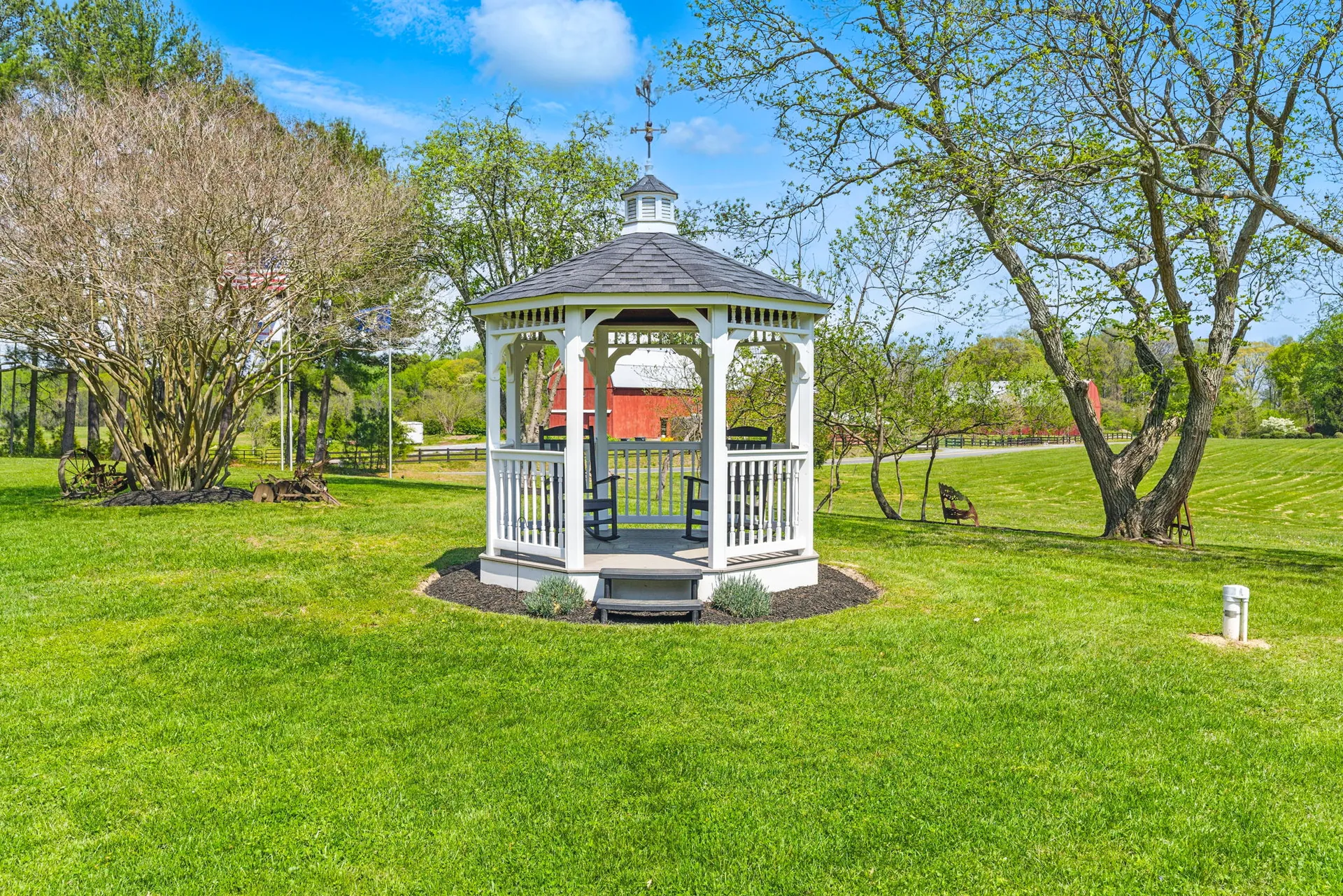 White gazebo surrounded by lawn and trees at Crimson Stag Farm