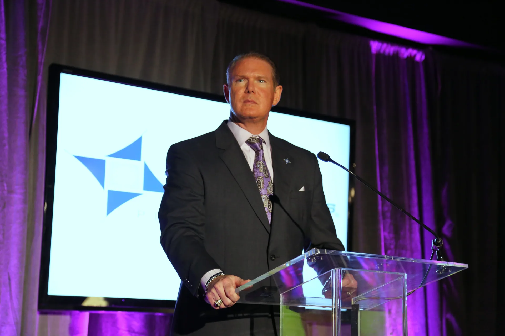 Donnie Downs speaking at a lectern during his Plan B Technologies career
